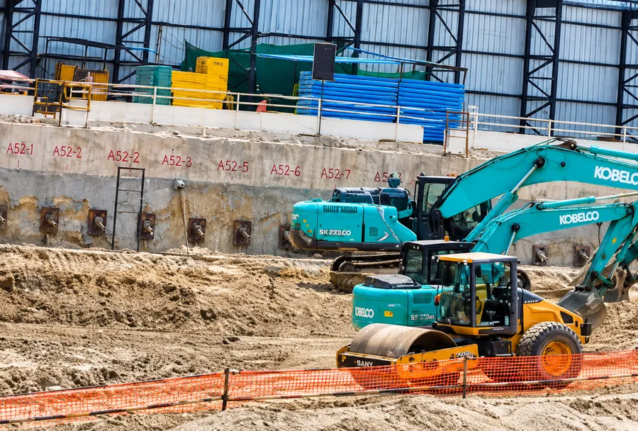 Roller and excavators on a Durga Buildwell site